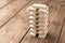 A pyramid of dominoes. Playing dominoes on a wooden table. The concept of the games is to relax. Selective focus