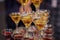 Pyramid of glasses with golden and red beverages, vine, wine, champagne, festive mood, celebration