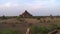 A pyramid looking building in a field