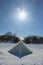 Pyramid made of Ice on a Frozen Lake in Sunshine