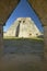 Pyramid of the Magician through archway door, a Mayan ruin in the Yucatan Peninsula, Mexico at sunset