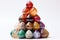 a pyramid of multicolored marbles on a white background