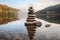 Pyramid of round gray stones on the bank of a mountain river. Zen and harmony concept.Stone tower