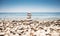 A pyramid of rounded stones of various shapes,sizes and shades.The stones lie one on top of the other from large