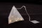 Pyramid shape teabag on the dark background