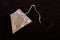 Pyramid shape teabag on the dark background