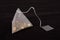 Pyramid shape teabag on the dark background