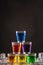 Pyramid of shots with colorful alcohol on ice