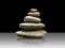 Pyramid or stack of gray stones gray on a dark gray background w