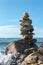 Pyramid of stacked stones on boulder on the inshore waves of Lake Baikal, balance and harmony concept