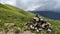 Pyramid of stacked stones with mountain range in the background