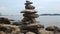 Pyramid of stone stack each other at the rocky beach. Balance rock or tower of stone