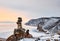 Pyramid of stones above ice lake