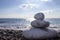 Pyramid stones balance on the sand of the beach