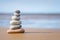 Pyramid stones balance on the sand of the beach. The object is in focus