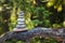 Pyramid stones balance on a tree trunk in the forest. Pyramid in focus, forest background is blurred