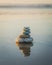 Pyramid of stones on the beach at sunset. Tranquil scene, relaxation, seaside vacation, meditation concept