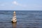 Pyramid from stones standing in the water on the coast of Estonia