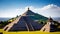 the pyramid of the sun in mexico with clouds on clear blue sky on the background