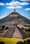 the pyramid of the sun in teotihuacan, mexico with clouds and blue sky on the background