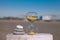 A pyramid of three stones next to an hourglass, stand on a wooden board on a blurred background