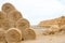 Pyramid of tightly twisted stacks of golden hay at the end of summer with place for copy space. Agriculture concept