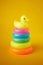 Pyramid toy. Circle Plastic Colorful. The newborn children bathing fun moments get baby and mother. Toys for Children on yellow ba