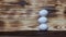 Pyramid of white chicken eggs on a brown wooden table