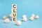 pyramid of wooden cubes with the word CLUE and wooden balls on a blue background