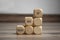 Pyramide made of cubes and dice with message Never give up on wooden background