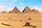 The Pyramids of Giza and camels in the desert of Egypt