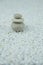 Pyramids of gray and white zen pebble meditation stones on white background. Concept of harmony