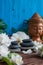 Pyramids of gray zen stones with white flowers, green leaves on wooden background. Concept of harmony, balance and meditation,