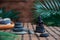 Pyramids of grey zen stones with green leaves and Buddha statue. Concept of harmony, balance and meditation, spa, massage, relax