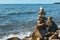 Pyramids of stacked stones on boulder on the inshore waves of Lake Baikal, scenic seascape, balance and harmony concept