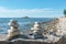 Pyramids of stacked stones on a rock on the beach of Lake Baikal, scenic seascape, balance and harmony concept