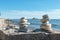 Pyramids of stacked stones on a rock on the beach of Lake Baikal, scenic seascape, balance and harmony concept