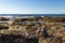 Pyramids of stones for meditation lying on sea coast. Stack of stones against blurred seascape, space for text. Zen concept.