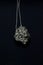 Pyrite gem, pyrite stone. Necklace on black background. Vertical imagem