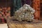 Pyrite Specimen on Raw Tigers Eye Rock With Dried Herbs in Background