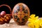 Pysanka, painted eggs in busket and spring daffodils. Easter eggs on black background. Holiday concept. Ethnic easter