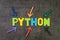 Python modern programming language for software development or application concept, multi color arrows pointing to the word Python