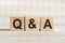 Q&A abbreviation - questions and answers, on wooden cubes on a light background