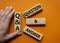 Q and A - Question and Answer. Wooden cubes with words Q and A. Businessman hand. Beautiful orange background. Business and Q and