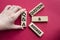 Q and A - Question and Answer. Wooden cubes with words Q and A. Businessman hand. Beautiful red background. Business and Q and A