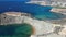 Qarraba Bay flat rock cape with golden sand beach aerial towards Riviera Beach