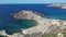 Qarraba Bay flat rock with golden sand beach aerial fly away Malta