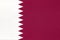 Qatar national fabric flag textile background. Symbol of world asian country