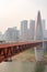 QianSiMen bridge with skyscrapers in the haze in Chongqing