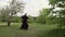 A qigong master and his disciple practice tai chi in nature in a park